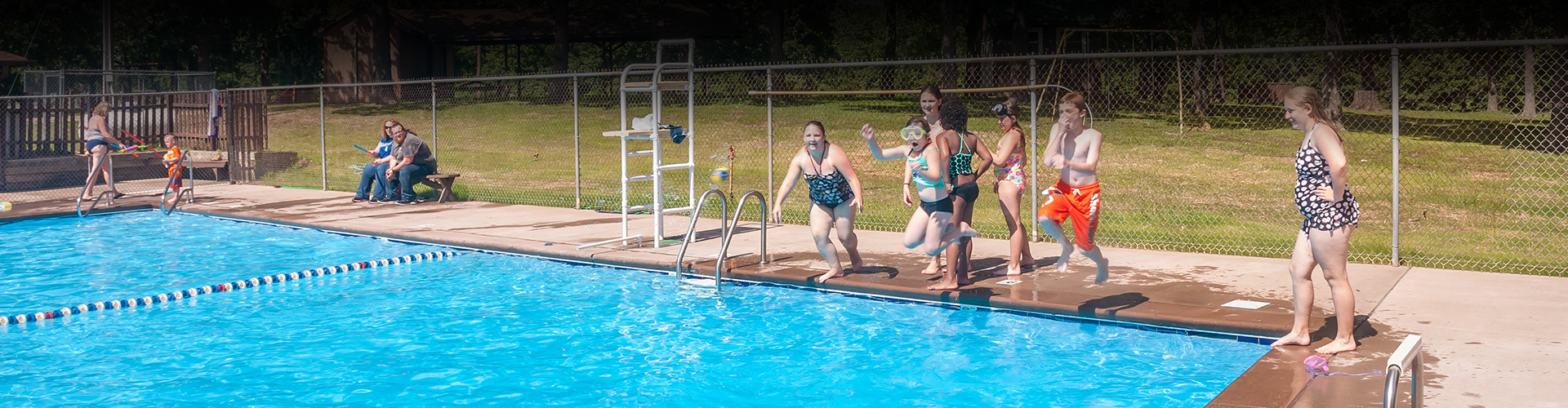 children and youth enjoying a pool at church camp