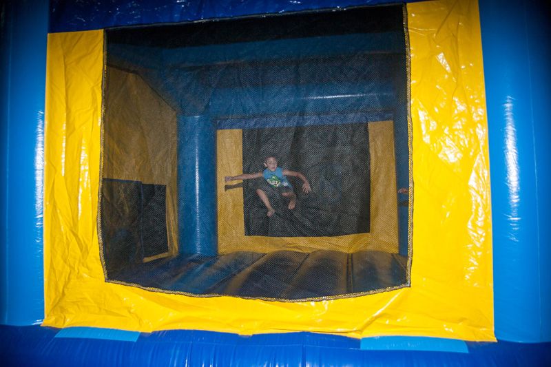 young boy jumping in bounce house