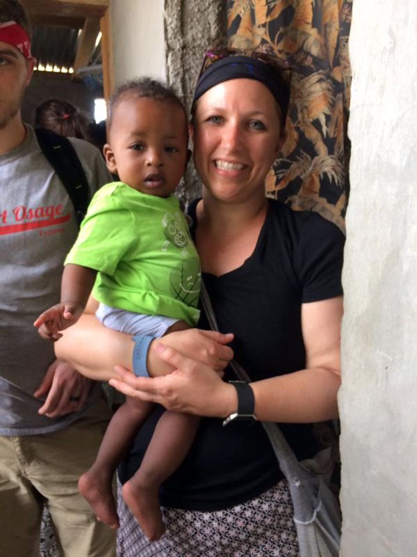 Melissa holding a young child on missions trip