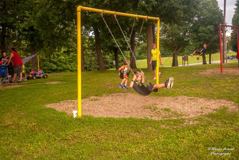 kids enjoying the park swings